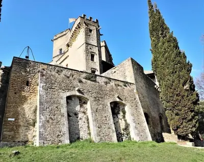an old building with a tower on top of it at Maison La Plaine in Lourmarin