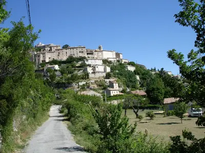 a village on top of a hill with houses at La Fontaine in Simiane-la-Rotonde
