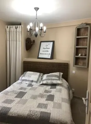 a bedroom with a bed with two pillows on it at Provence Luberon Bonnieux location gite chez Marcelle in Bonnieux