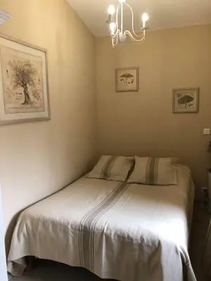 a bedroom with a bed with a white blanket at Provence Luberon Bonnieux Location Gite Chez Basile in Bonnieux
