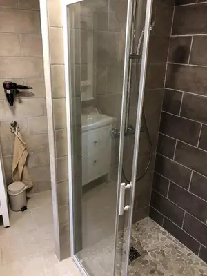 a shower with a glass door in a bathroom at Provence Luberon Bonnieux Location Gite Chez Basile in Bonnieux