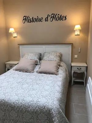 a bedroom with a bed with a sign above it at Provence Luberon Bonnieux Location Gite Chez Basile in Bonnieux