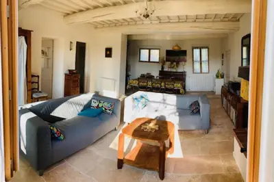 a living room with a couch and a table at Stone house in Isle-sur-la-Sorgue in LʼIsle-sur-la-Sorgue