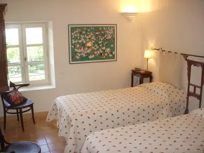 a bedroom with two beds and a window at Chez Manon in Apt