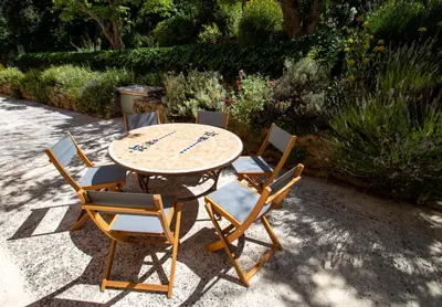 a table with four chairs and a table with at Chez Manon in Apt
