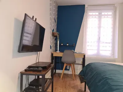 a bedroom with a bed and a desk with a television at Studio Bon pasteur hyper centre Aix in Aix-en-Provence