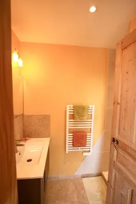 a bathroom with a sink and a towel rack at Mas du Figuier Oppede Luberon in Oppède