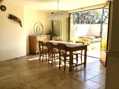 a dining room with a table and some chairs at Mas du Figuier Oppede Luberon in Oppède