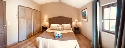 a bedroom with a large bed with two pillows at La Bri...Gite in LʼIsle-sur-la-Sorgue