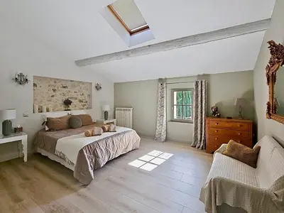a bedroom with a bed and a dresser and a window at La Bri...Gite in LʼIsle-sur-la-Sorgue