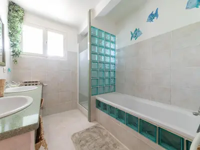 a bathroom with a tub and a sink at Relaxing Provence Hideaway in Carpentras