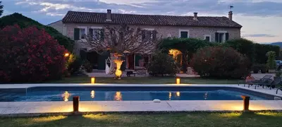 a house with a swimming pool in front of a house at Mas La Pomarede in Robion en Luberon