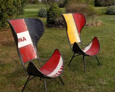 two chairs sitting in the grass in a yard at Mas La Pomarede in Robion en Luberon