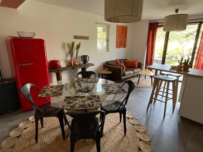 a kitchen and living room with a table and chairs at Domaine Hestia in Robion en Luberon