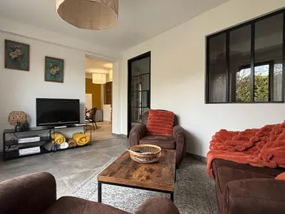 a living room with two couches and a tv at Domaine Hestia in Robion en Luberon