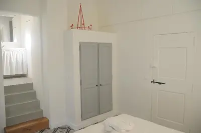 a white bathroom with a glass door and stairs at Villa Vagabonde in Gordes