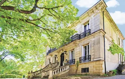 an old stone house with stairs and trees at Embarben Maison d'hôtes in Saint-Chamas
