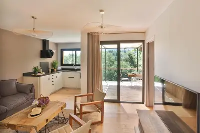 a living room with a couch and a table at Les Cabanes de la Fontaine in Lacoste