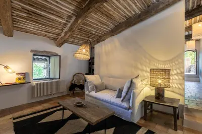 a living room with a couch and a table at Le Domaine du Castellas in Sivergues