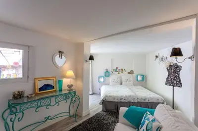 a bedroom with a bed and a couch at La maison de Tao in Aix-en-Provence
