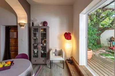 a room with a table and a chair and a window at La maison de Tao in Aix-en-Provence