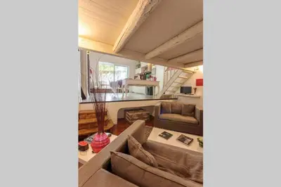 a living room with a couch and a table at La maison de Tao in Aix-en-Provence
