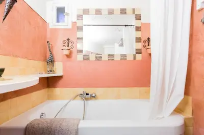 a bathroom with a tub and a sink at La maison de Tao in Aix-en-Provence