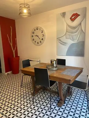 a table with a mirror on top of a wall at Maison de charme Isle sur la Sorgue in LʼIsle-sur-la-Sorgue
