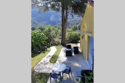 a view of a patio with a table and chairs at Vue panoramique sur le château,montagne et grottes in Fontaine-de-Vaucluse