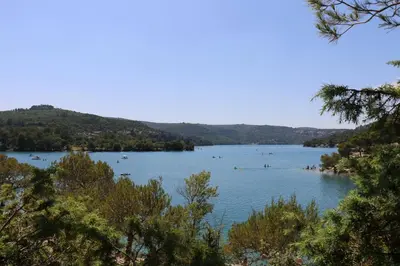 a view of a lake with people swimming in it at Studio charmant au calme in Aix-en-Provence
