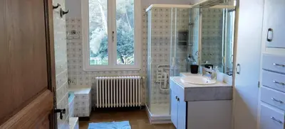 a bathroom with a sink and a glass shower at Loue haut de villa au calme piscine jardin arboré in Cornillon-Confoux