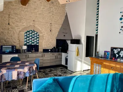 a kitchen with a table and a blue couch in a room at 