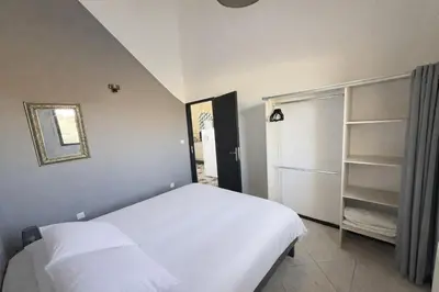 a bed with white sheets and pillows in a bedroom at 