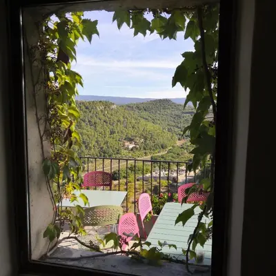 a view of a table and chairs from a window at Les Maisons Mado in Venasque