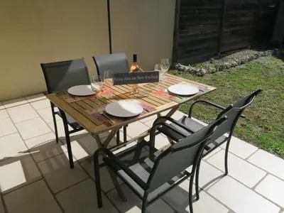 a wooden table with four chairs around it at Chez Marielle in LʼIsle-sur-la-Sorgue