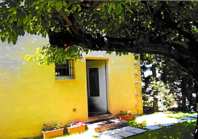 a yellow house with a door and a window at Appartement lumineux à Lançon-Provence, piscine partagée in Lançon-Provence