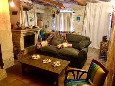 a living room with a couch and a table at Les Volets Bleus Provence in Salon-de-Provence