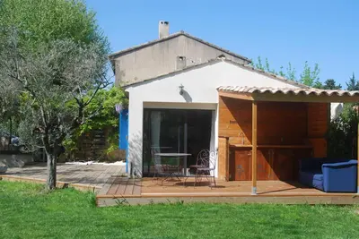 a small house with a patio and a table at Les Volets Bleus Provence in Salon-de-Provence