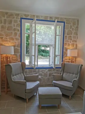 a living room with two chairs and a window at Mas de Férigoulet -