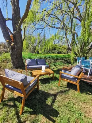 three lounge chairs and a table and a tree at Mas de Férigoulet -