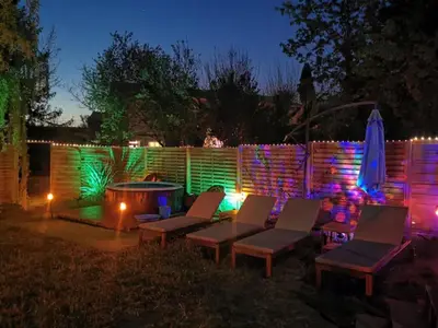 a backyard with chairs and a fire pit at night at Mas de Férigoulet -
