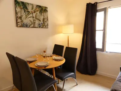 a dining room with a wooden table and chairs at LE BEDARRIDE in Aix-en-Provence