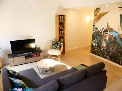a living room with a couch and a flat screen tv at LE BEDARRIDE in Aix-en-Provence