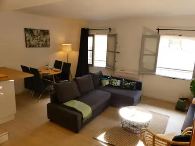 a living room with a couch and a table at LE BEDARRIDE in Aix-en-Provence