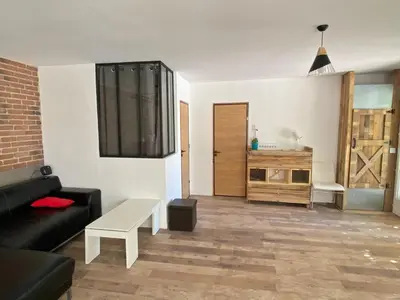 a living room with a couch and a table at Maison dans quartier calme in LʼIsle-sur-la-Sorgue