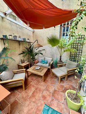 an outdoor patio with tables and chairs and plants at Dar Saad Appartement terrasse climatisation centre d Aix in Aix-en-Provence