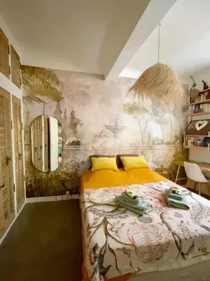 a bedroom with a bed and a painting on the wall at Dar Saad Appartement terrasse climatisation centre d Aix in Aix-en-Provence