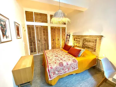 a bedroom with a bed in a room with windows at Dar Saad Appartement terrasse climatisation centre d Aix in Aix-en-Provence