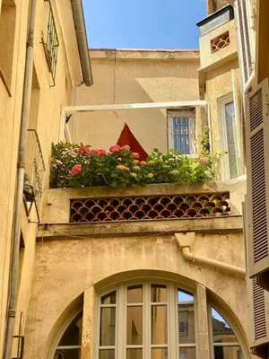 a window box with flowers on a building at Dar Saad Appartement terrasse climatisation centre d Aix in Aix-en-Provence