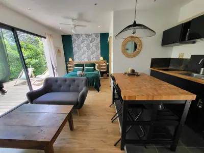 a living room with a couch and a table at Le Phoenix de Sainte Victoire in Saint-Marc-Jaumegarde